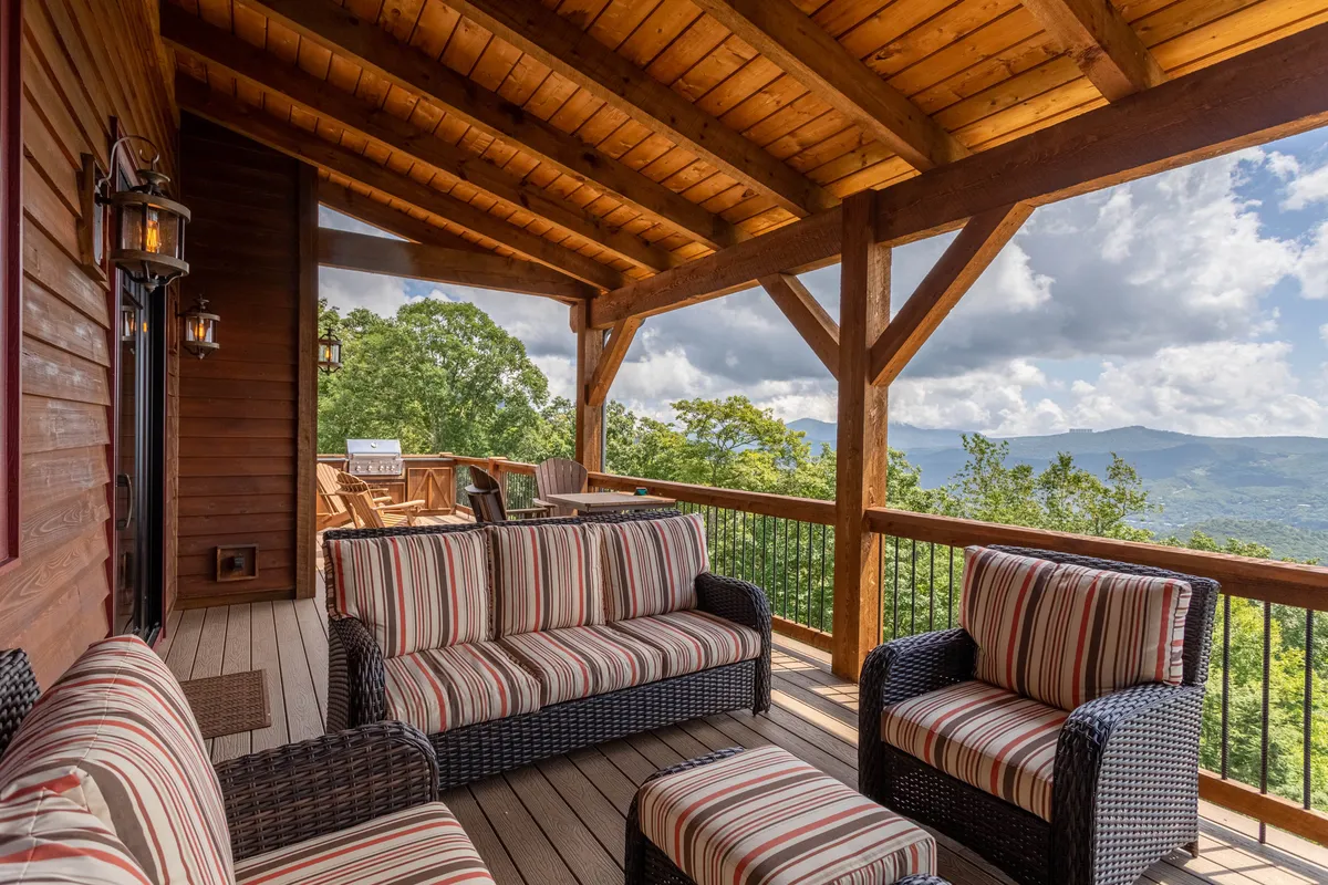 This image spotlights striped outdoor furniture arranged to enjoy a stunning mountain vista. The inviting setup encourages relaxing, socializing, and taking in sunrise, sunset, or star-filled skies.